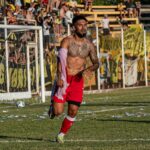 Unforgettable soccer player's celebration in a vibrant outdoor match setting.