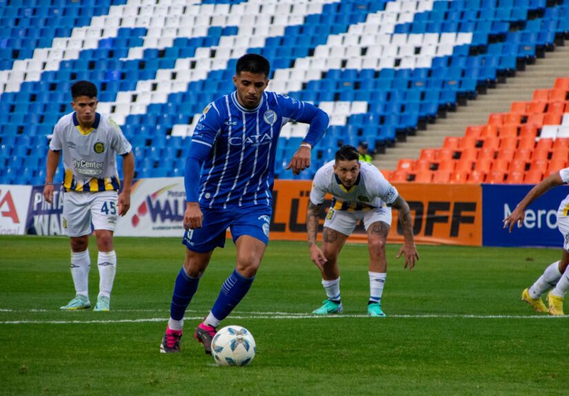 Players in a soccer match on a vibrant stadium field, showcasing teamwork and competition.