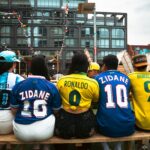 Group of people wearing soccer jerseys at an outdoor venue in Chicago, enjoying a lively atmosphere.