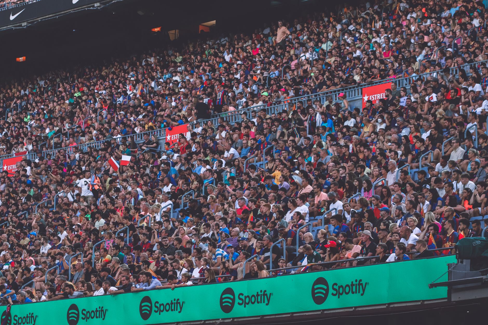 A packed stadium with enthusiastic fans cheering, showcasing diverse spectators.