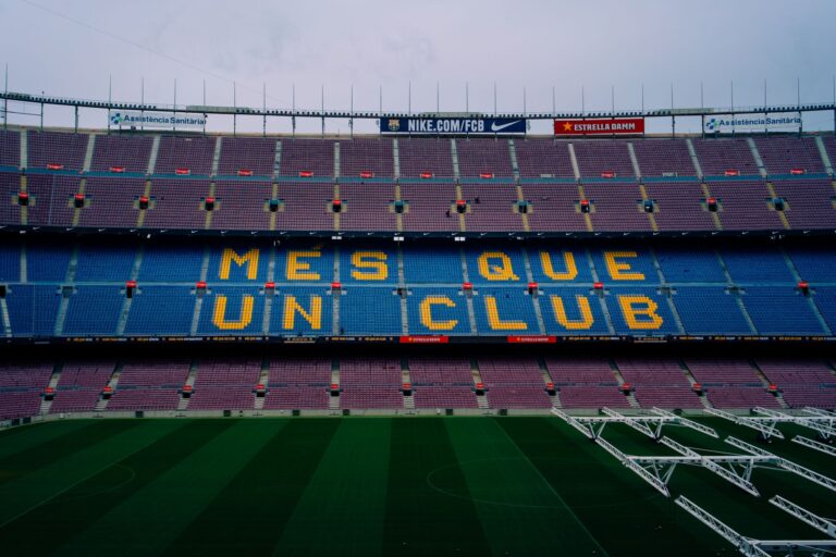 View of Camp Nou stadium seating displaying 'Mes Que Un Club' in Barcelona, Spain.