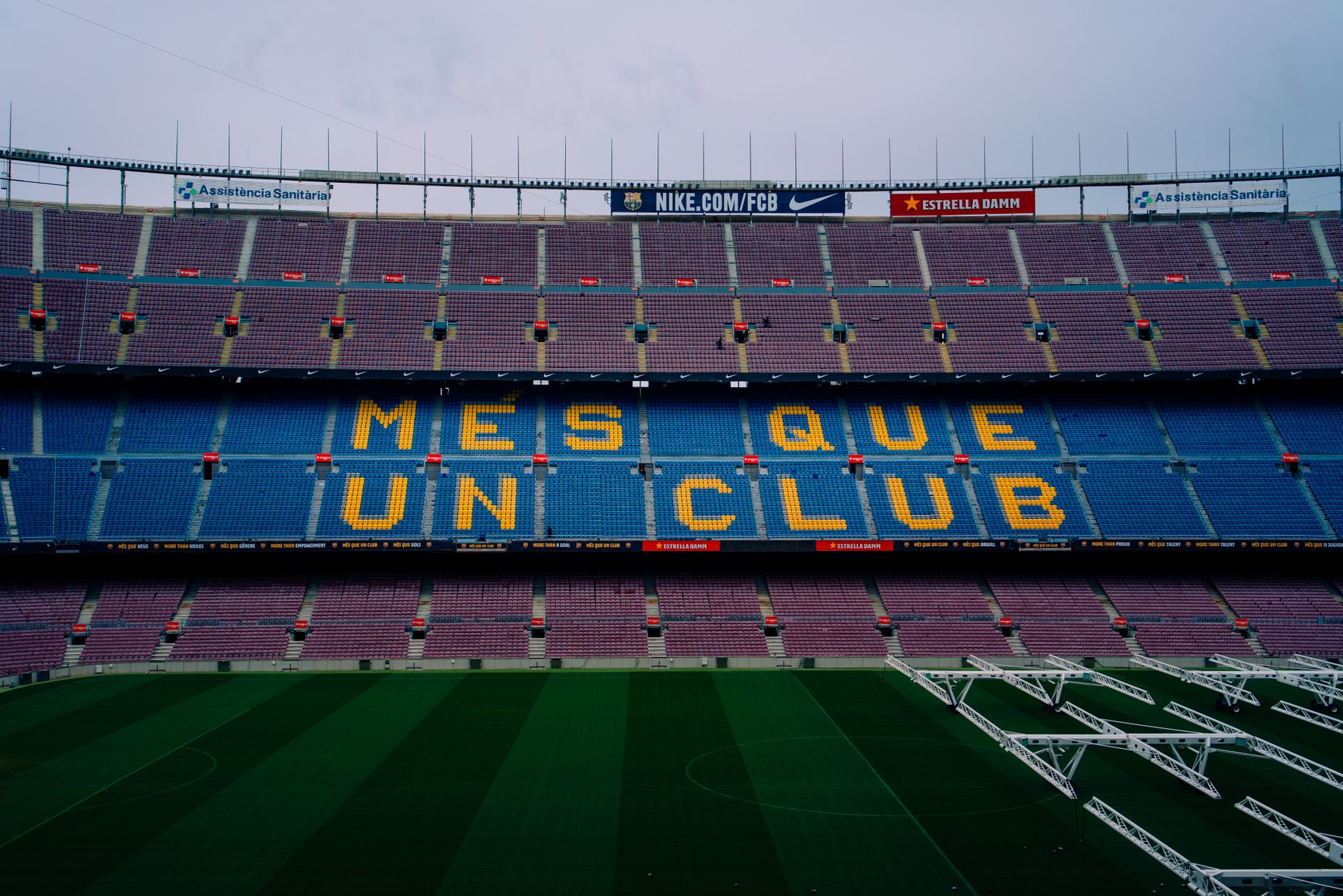 View of Camp Nou stadium seating displaying 'Mes Que Un Club' in Barcelona, Spain.