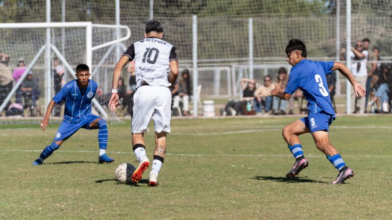 Dynamic action shot capturing players during a competitive soccer match outdoors.