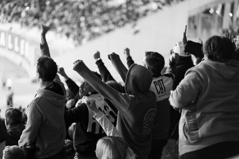 A crowd of enthusiastic football fans cheering inside a stadium in Córdoba, Argentina.