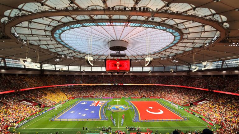 Vibrant soccer match at BC Place, Vancouver, showcasing international team flags.