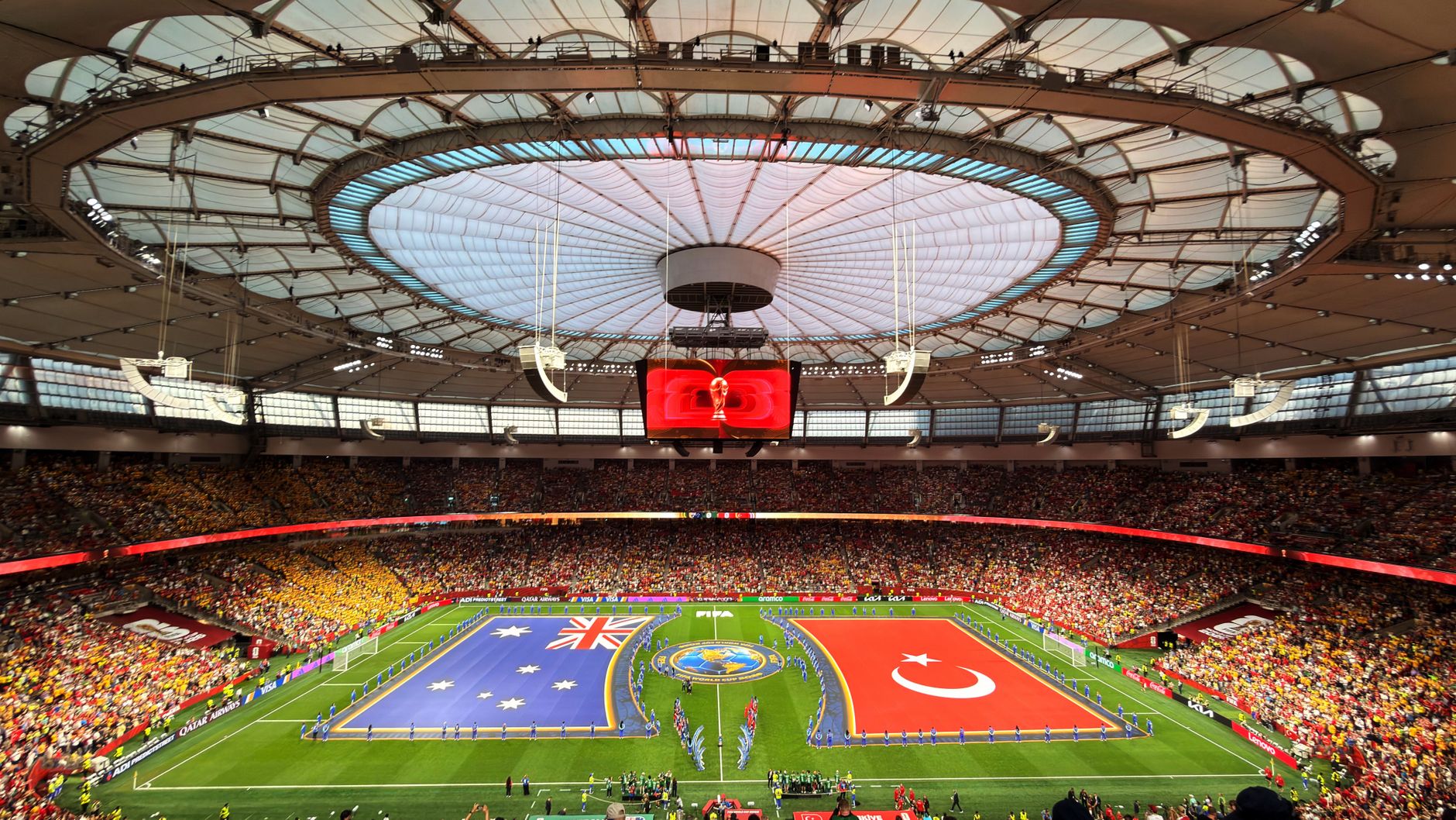 Vibrant soccer match at BC Place, Vancouver, showcasing international team flags.