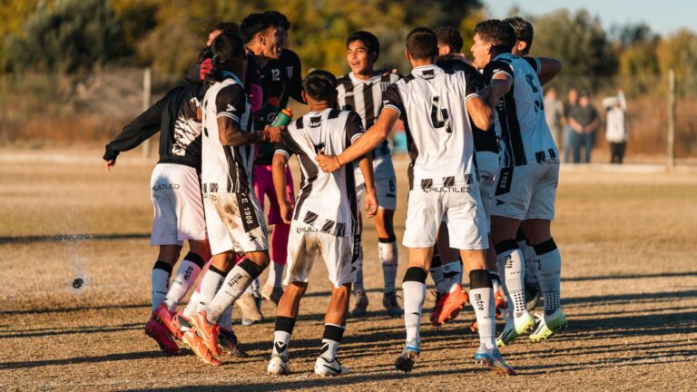 Youth soccer team jubilantly celebrating after a match during the day outdoors.