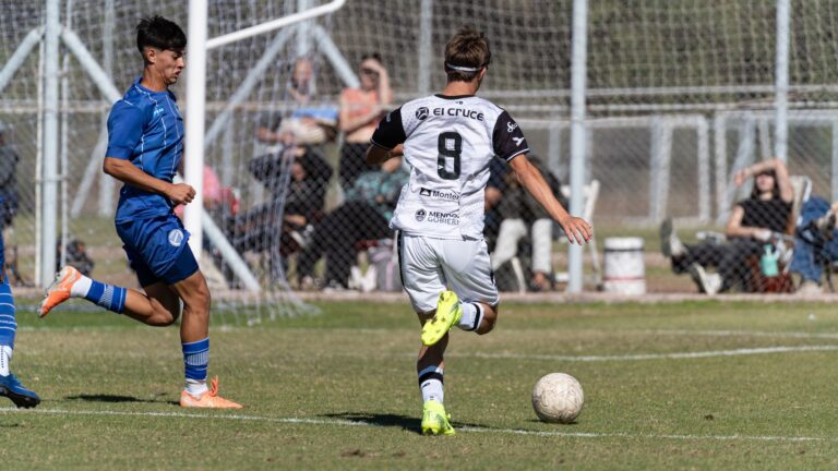 Action shot of soccer players during an outdoor match, highlighting competition.