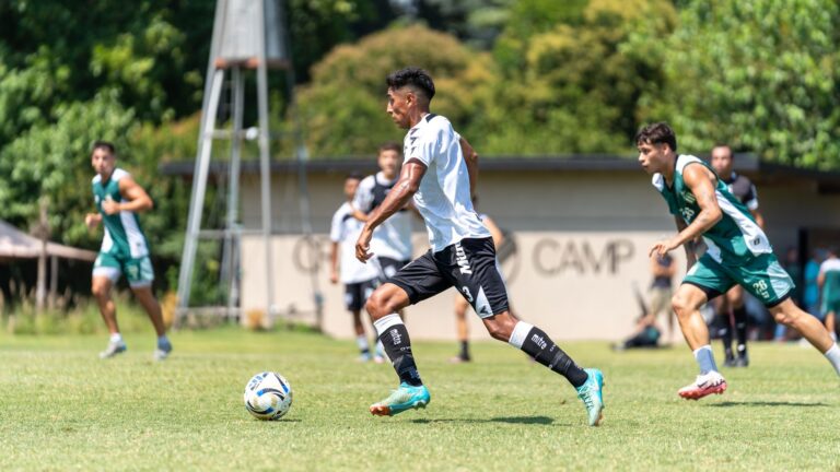 Players in action during a riveting soccer match on a sunny day outdoors, showcasing athletic skill and competition.