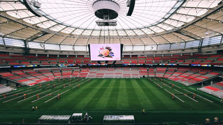 Interior view of BC Place Stadium in Vancouver, showcasing its vast seating and advanced roof structure.