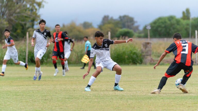 Dynamic youth soccer match with players in action outdoors on a grassy field.