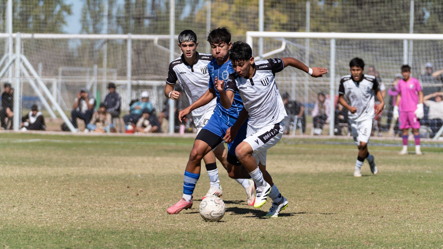 Action-packed youth soccer match with players competing fiercely outdoors.