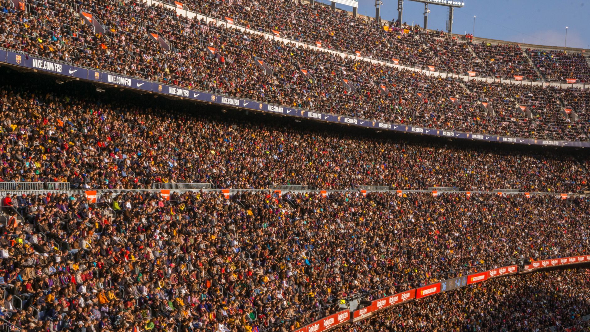 A vibrant crowd fills Camp Nou stadium, Barcelona during a football match.