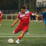 Football player in action on the pitch, showcasing athletic skill.