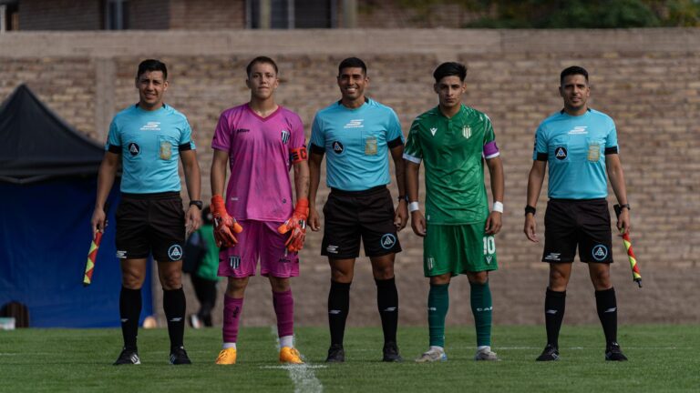 Soccer team and referees in uniform standing on the field before a match.