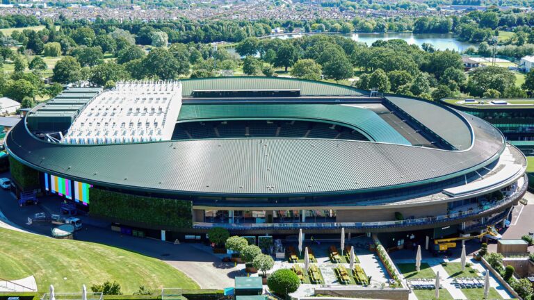 Arial shot of the iconic Wimbledon tennis stadium in the summer.