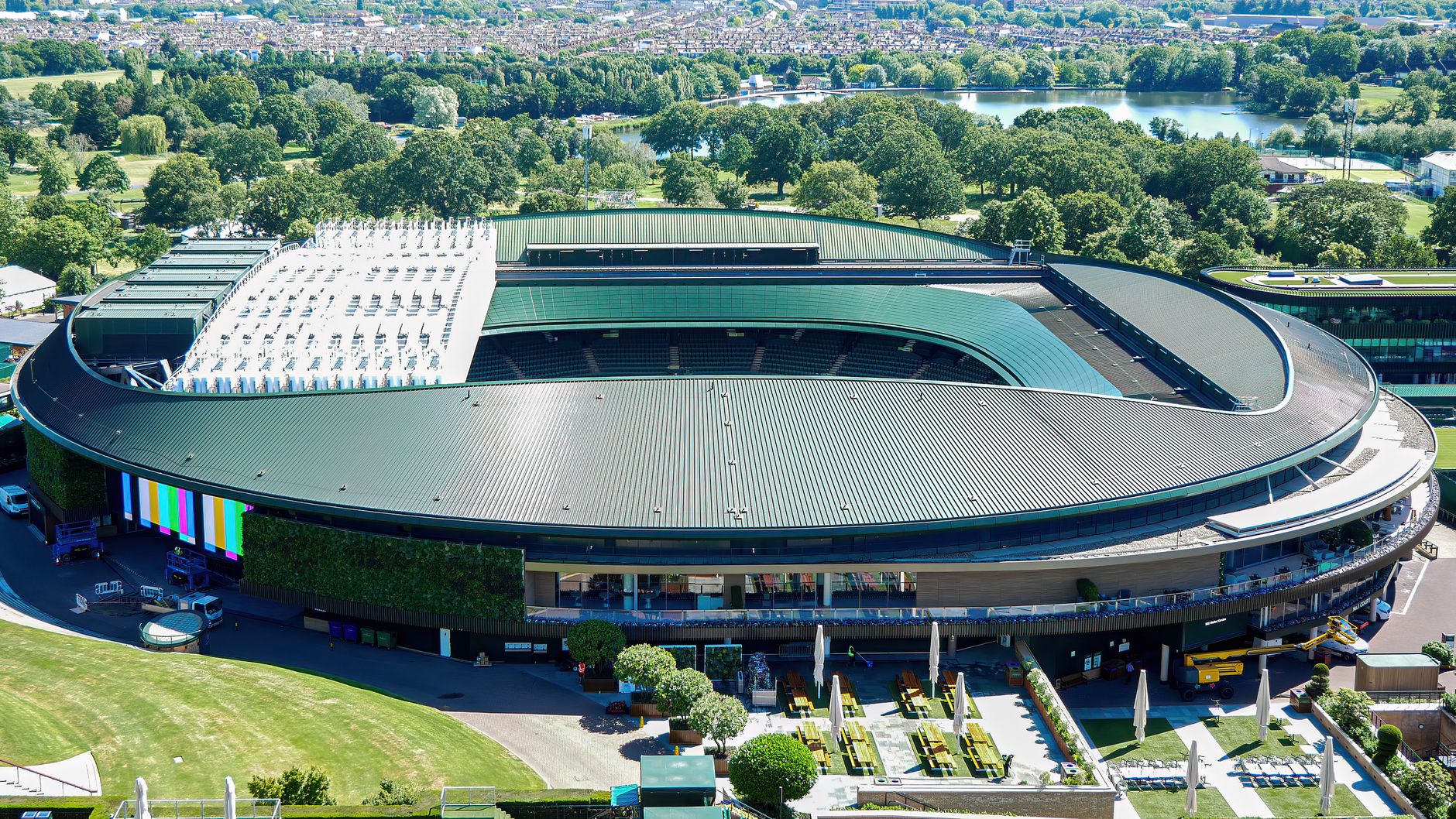 Arial shot of the iconic Wimbledon tennis stadium in the summer.