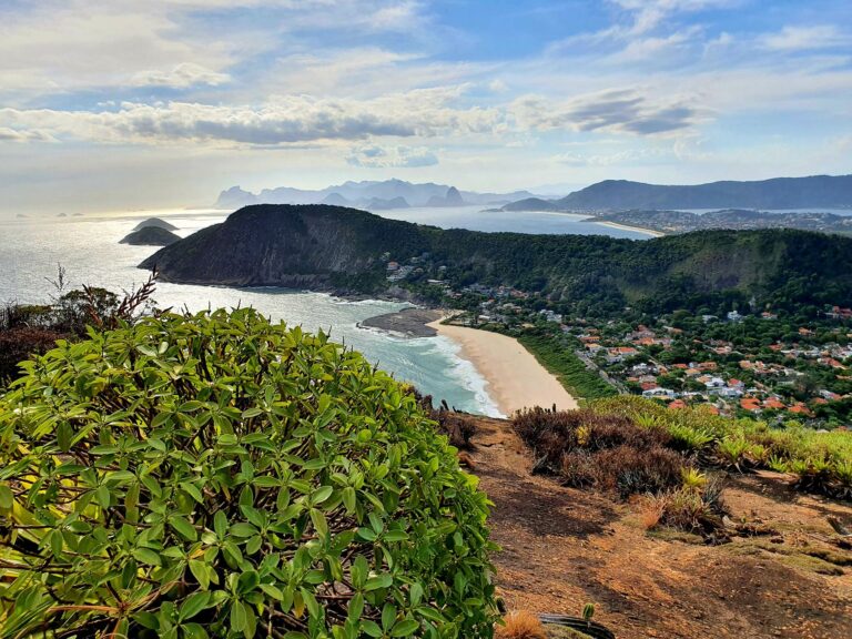A stunning aerial view of Itacoatiara Beach with lush greenery and ocean in Rio de Janeiro, Brazil.