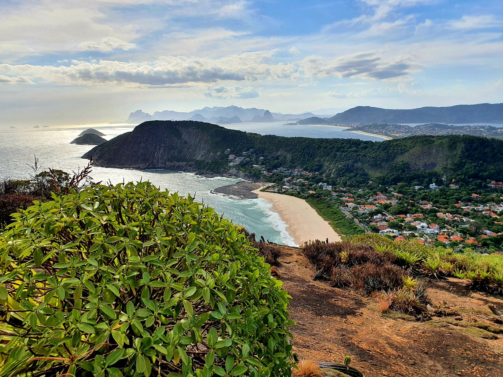 A stunning aerial view of Itacoatiara Beach with lush greenery and ocean in Rio de Janeiro, Brazil.