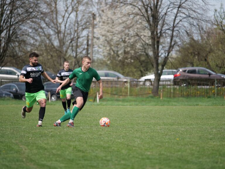 Action shot of an amateur soccer match in a park, showcasing teamwork and skill.
