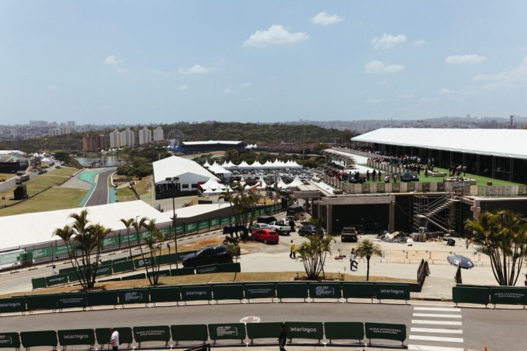 A bustling scene at Interlagos Circuit, showcasing racing event activities under sunny skies.
