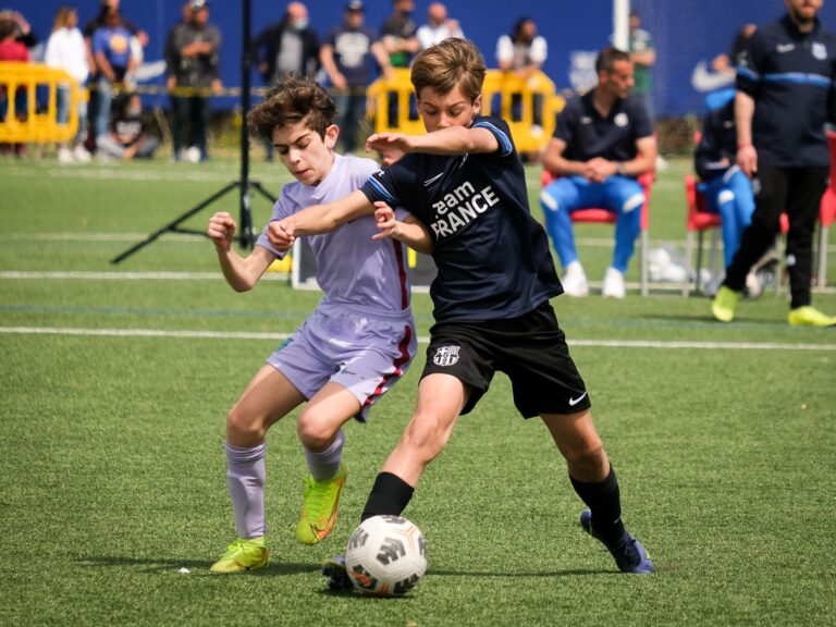 Young athletes compete in a lively soccer match in Barcellona, Italy, showcasing teamwork and sportsmanship.