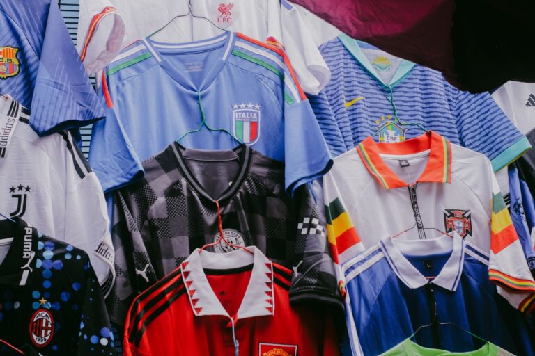 Various vintage soccer jerseys hanging on display, showcasing international teams' designs.