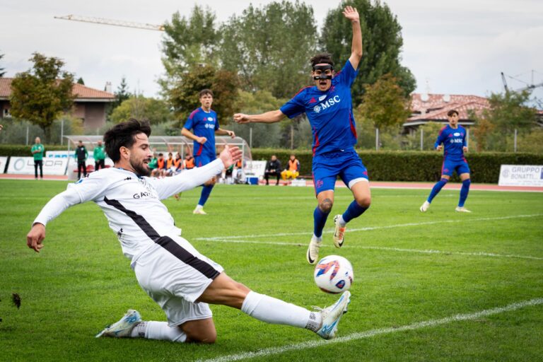 Dynamic moment of a soccer game with players in action on a sunny outdoor field.