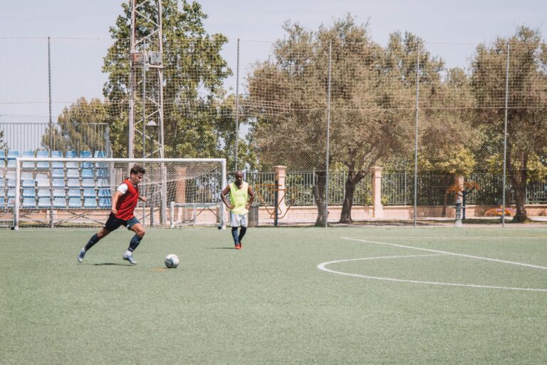 Two soccer players practicing on an outdoor pitch in Málaga, Spain.