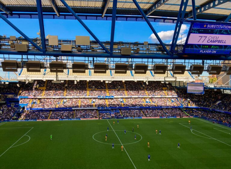 A lively football match in Stamford, England capturing the crowd and players in a filled stadium.