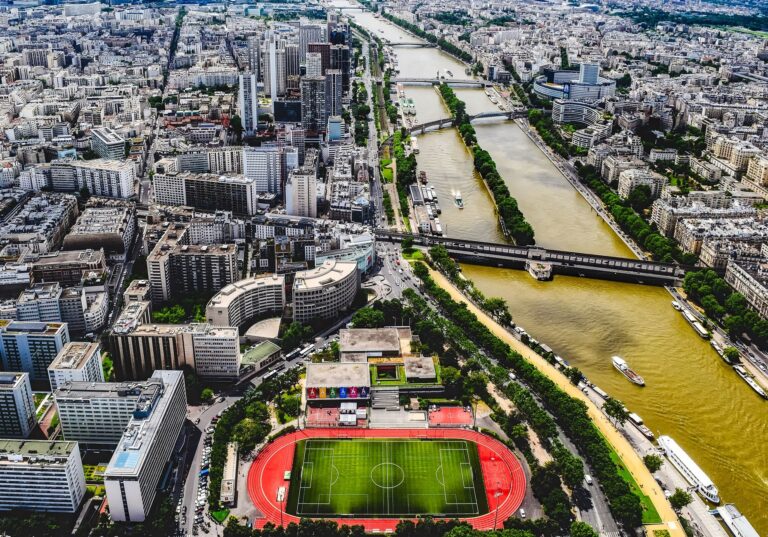 A stunning aerial shot of Paris cityscape featuring the River Seine and surrounding architecture.