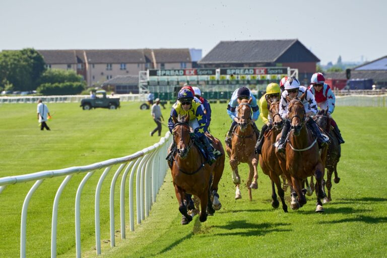 Jockeys compete intensely at the Musselburgh Racecourse in Scotland, showcasing equestrian skill and speed.