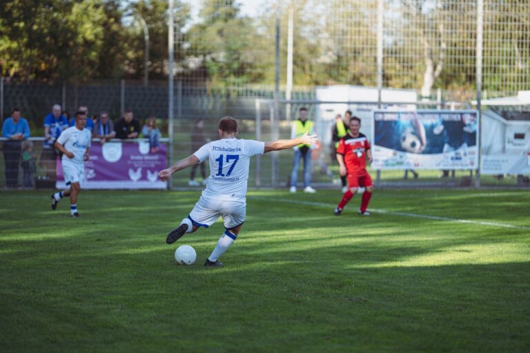 Action-packed soccer game with players in motion on a sunlit field, showcasing competitive spirit.