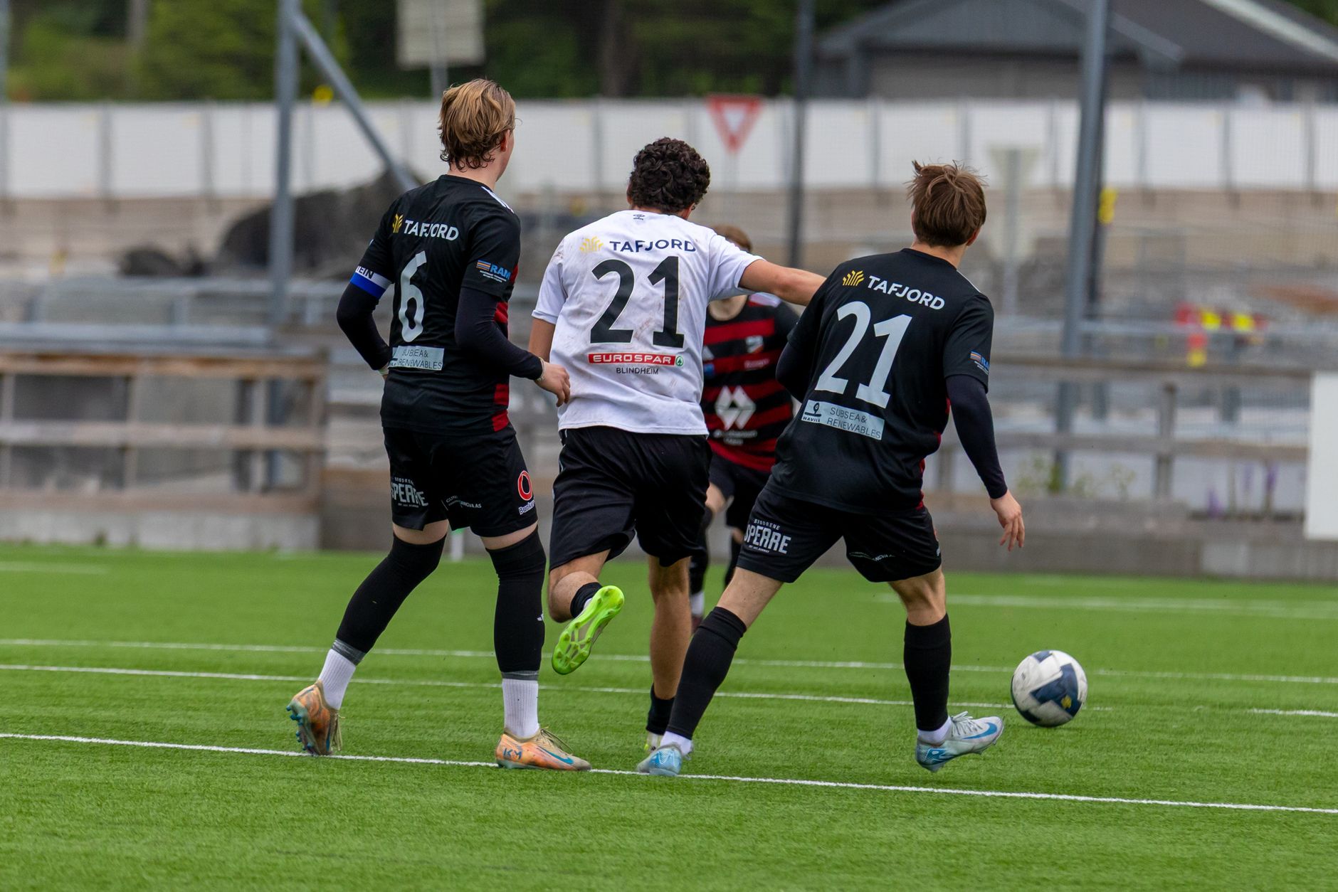 Action-packed European football match on a sunny day in Norway.