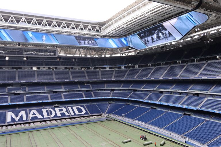 Explore the modern architecture of Santiago Bernabéu Stadium in Madrid, Spain, with its iconic branding.