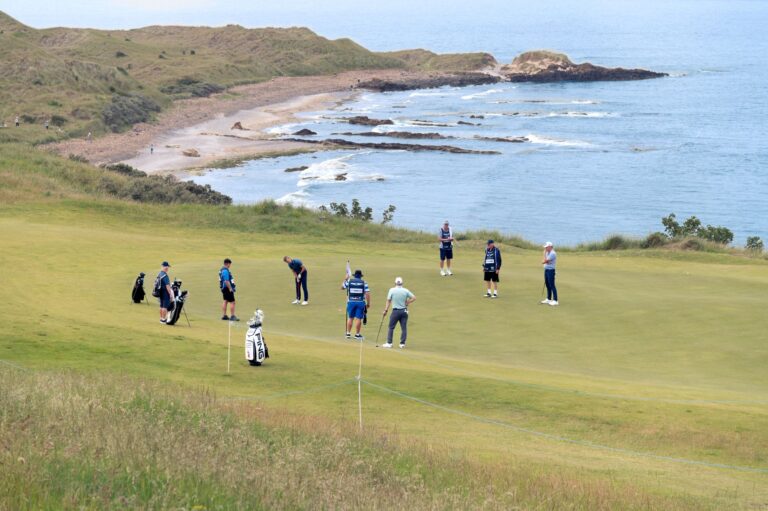Golfers enjoy a game on a coastal course with stunning ocean views.