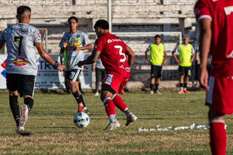 Intense soccer match with players in action on outdoor field, showcasing teamwork and sportsmanship.
