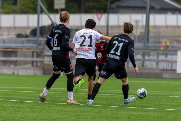 Action-packed European football match on a sunny day in Norway.