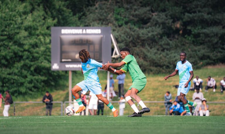 Players compete in a thrilling soccer match at Rennes, showcasing sportsmanship.