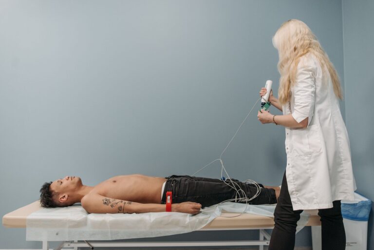 A medical professional examines a patient using diagnostic equipment in a clinic setting.