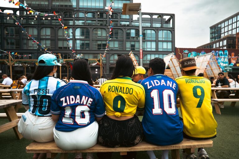Group of people wearing soccer jerseys at an outdoor venue in Chicago, enjoying a lively atmosphere.