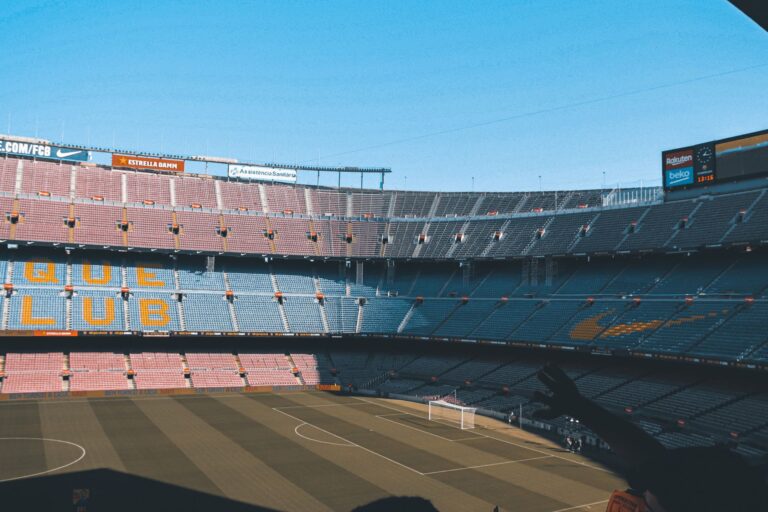 Wide shot of the iconic Camp Nou stadium in Barcelona, showcasing empty seats and football field.