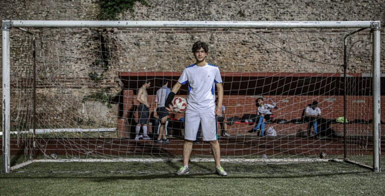 A young soccer player standing in front of a goal with a ball in Istanbul, Turkey.