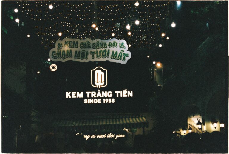 Beautiful night scene in Hanoi showcasing Kem Tràng Tiền ice cream shop decorated with lights.