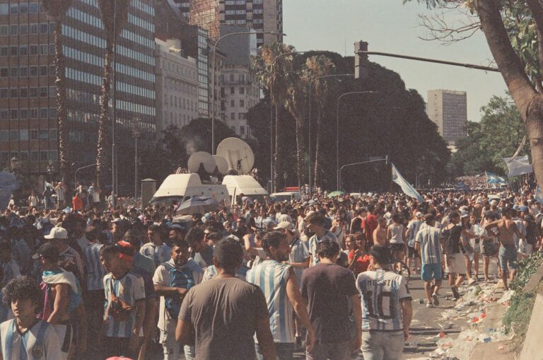Lively street scene with football fans celebrating in Buenos Aires, Argentina.