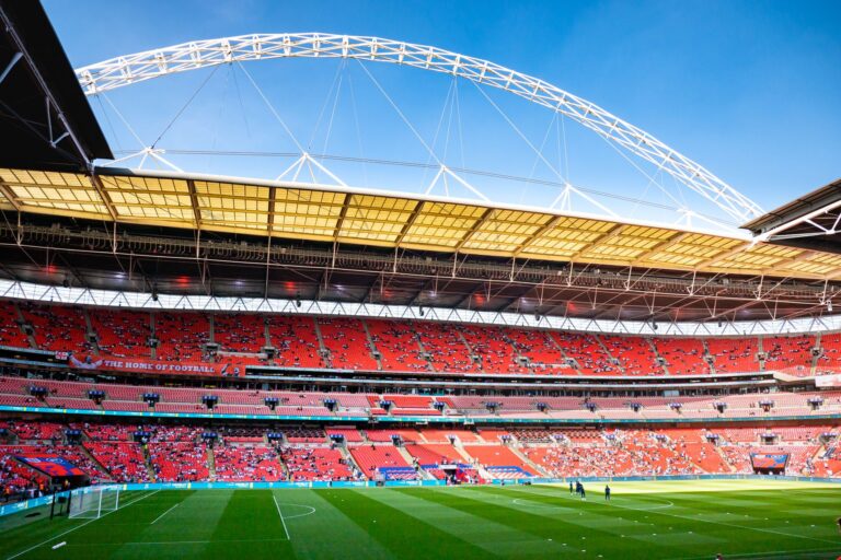 Stunning view of Wembley Stadium, England's iconic football venue, under clear blue skies.