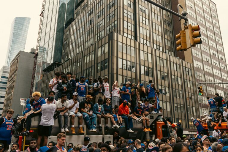 A lively gathering of people in New York City celebrating a sports event outdoors.