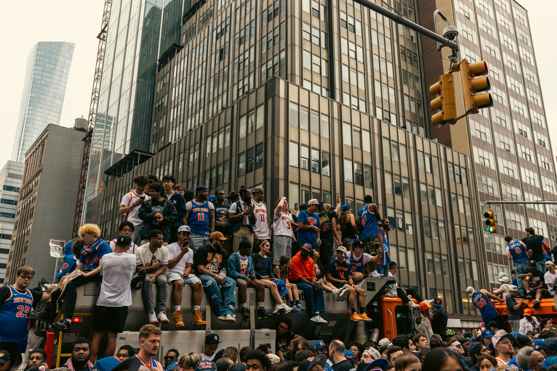 A lively gathering of people in New York City celebrating a sports event outdoors.