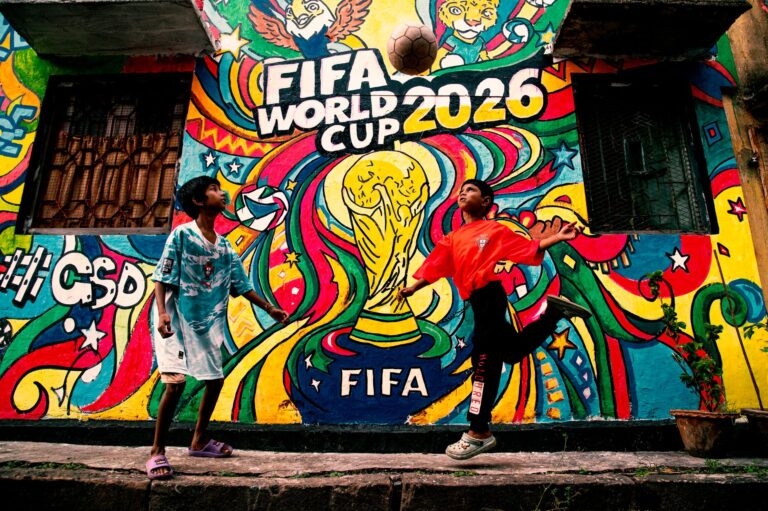 Vibrant mural of FIFA World Cup 2026 with kids playing soccer in the foreground.