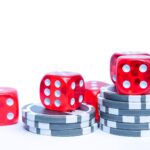 Vibrant red dice stacked with poker chips, ideal for gambling themes.